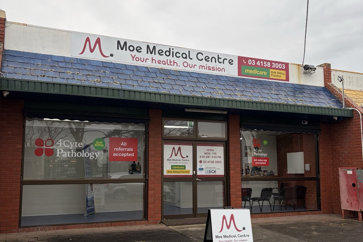 The red-brick shopfront of Moe Medical Centre on Lloyd Street, with the practice name and phone number on a white sign above the windows, and a level entrance from the footpath.