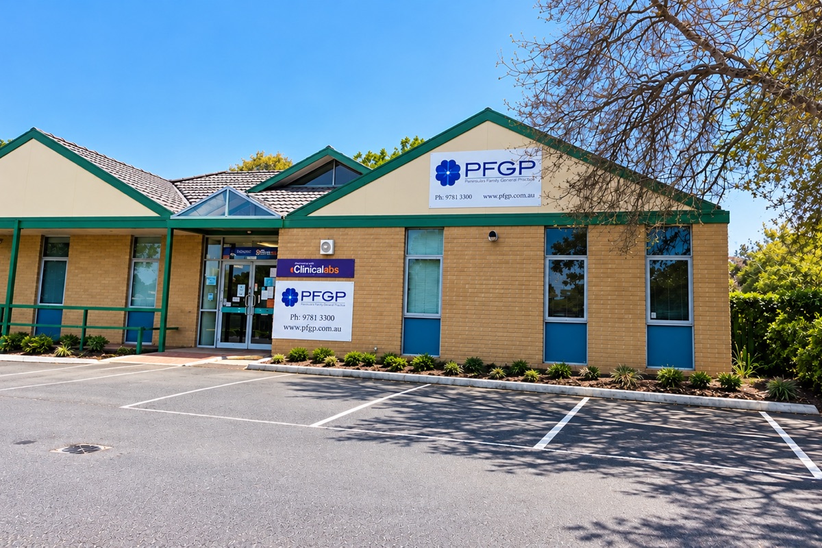 The single-storey brick clinic at 1B Vera Street, its cream gable carrying a PFGP Peninsula Family General Practice sign with the practice phone number and web address. A matching sign and a Clinical Labs pathology sign sit beside the glass entrance doors, which are reached on the level from the car park.